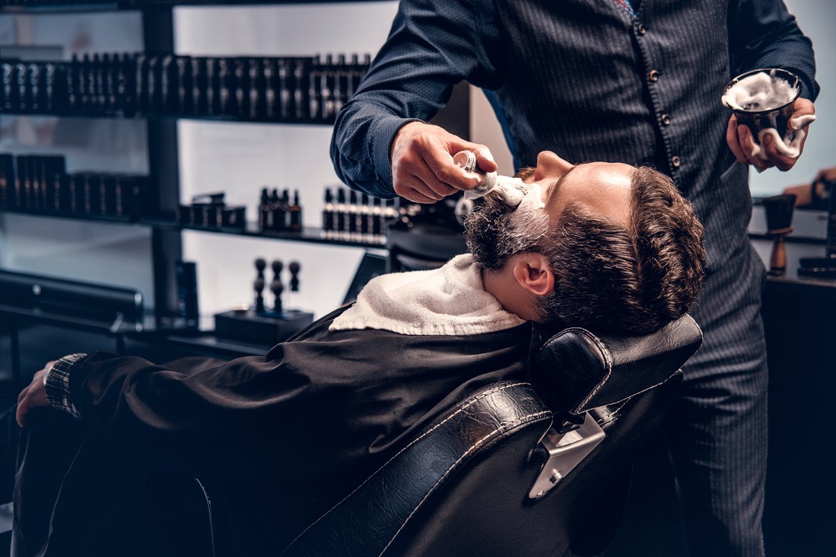 barber haircut with clippers in a barber shop